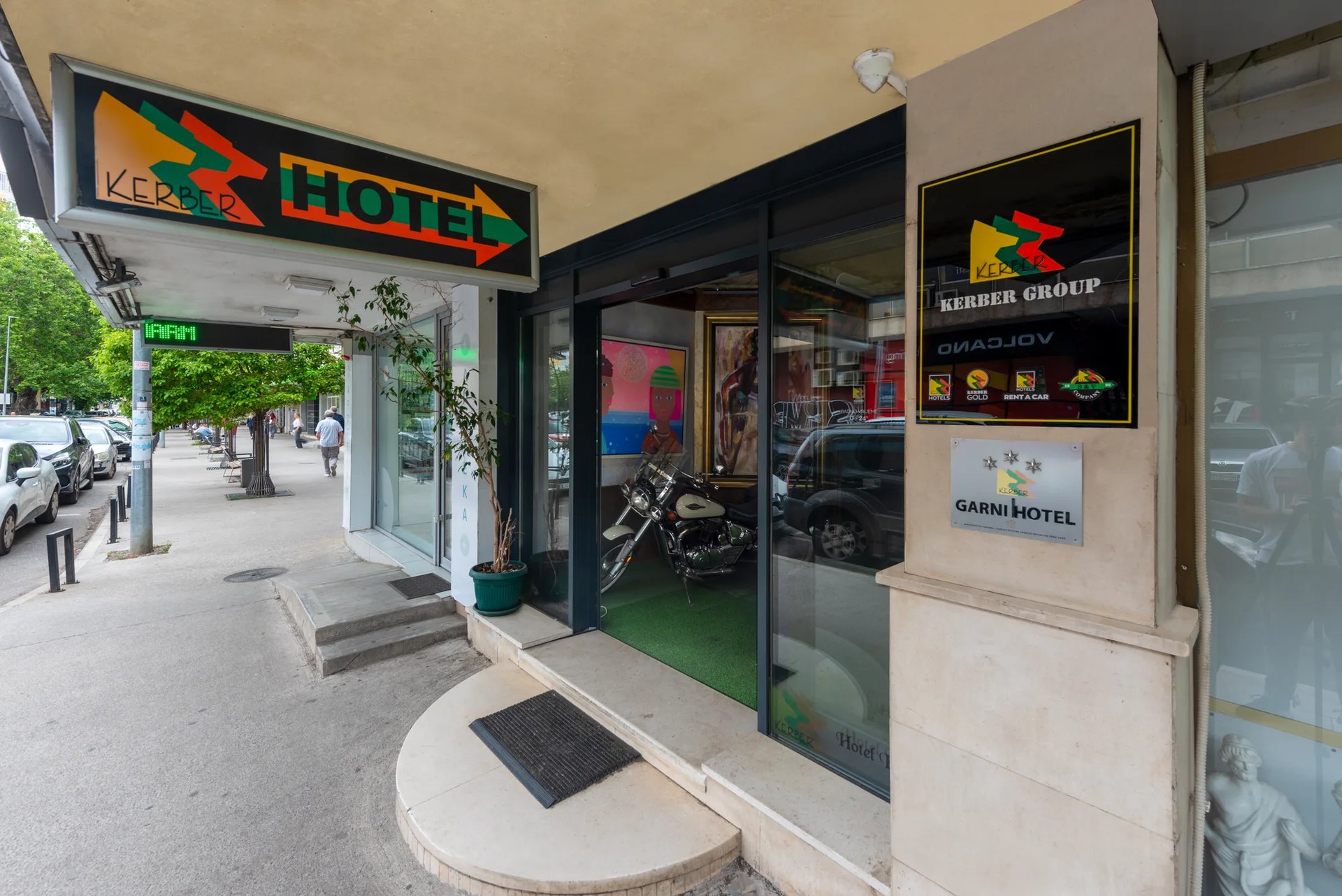 The entrance of Hotel Kerber, with a vintage motorbike in the lobby window